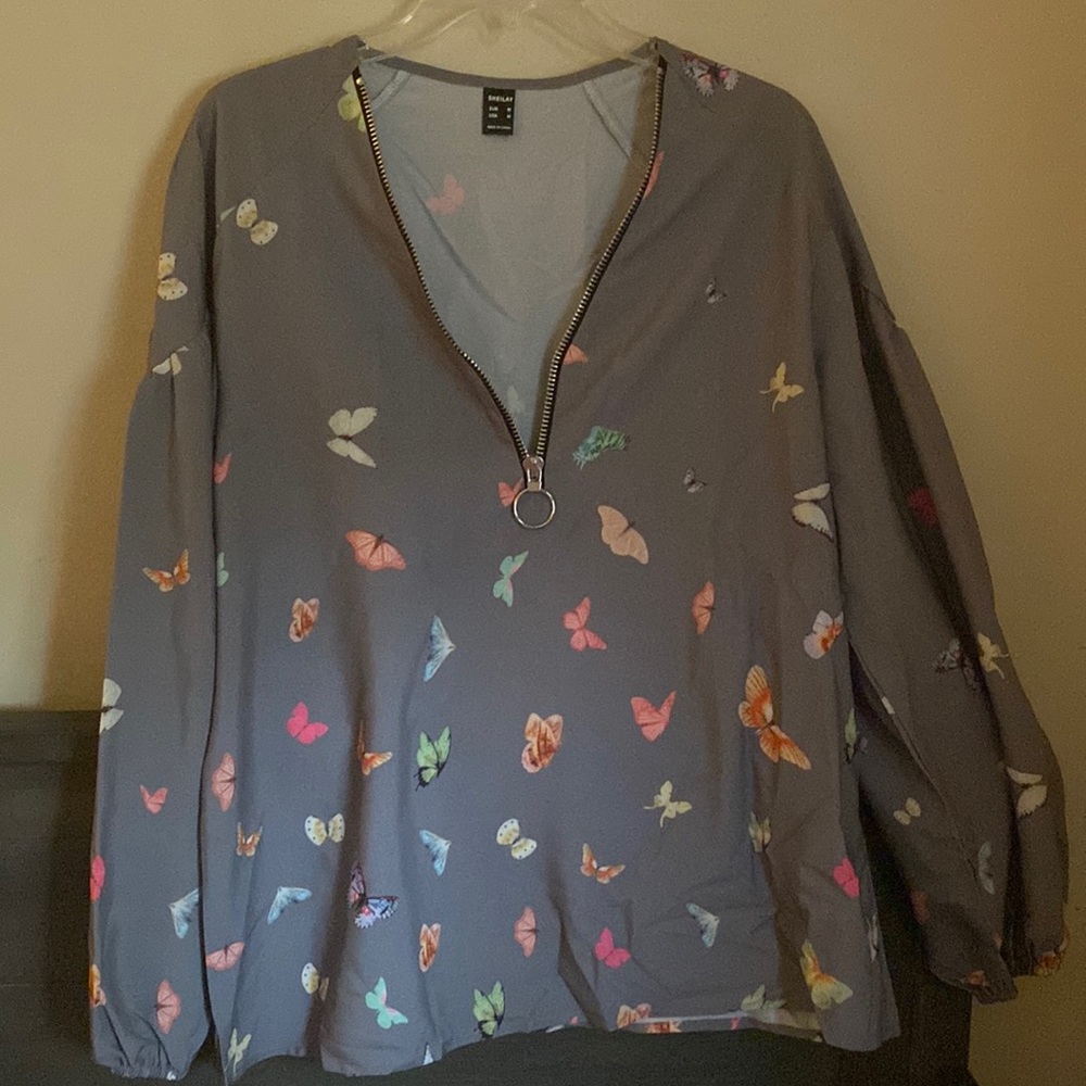 Butterfly printed half zip wind breaker.